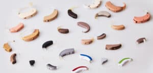 Various hearing aids on white background, displaying high quality hearing aids at a different hearing aid cost.