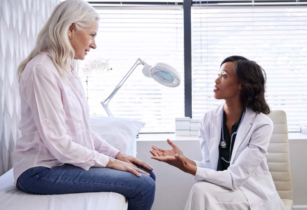 Mature woman in a consultation with a hearing aid to check her hearing to see if she needs a premium hearing aid