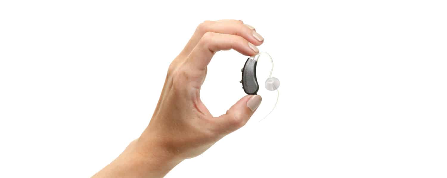 Protect hearing aid against the heat. Hand holding best hearing aids