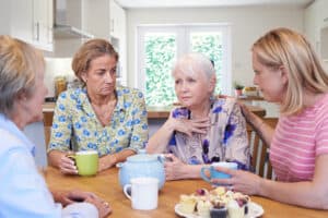 Woman around a table discussing the relationship between dementia and hearing loss
