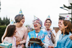 Woman with age-related hearing loss celebrating her birthday with her family