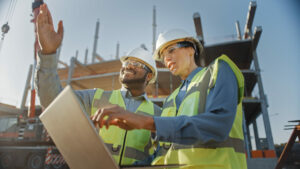 Man and woman at a construction site, a common source of noise-induced hearing loss