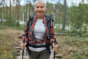 elderly woman hiking, showing that there is a way to go out with hearing aids
