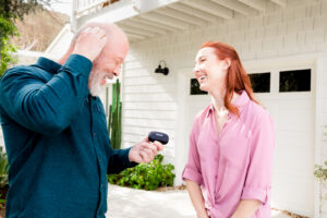 Man explaining the hearing aid fitting process to his daughter