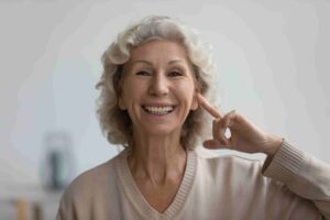 Woman pointing to hear ear considering types of hearing protection