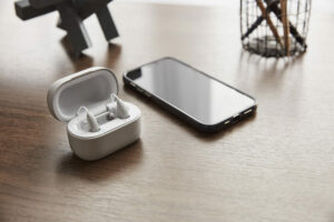Lexie B2 Bluetooth Hearing Aids with smartphone on desk